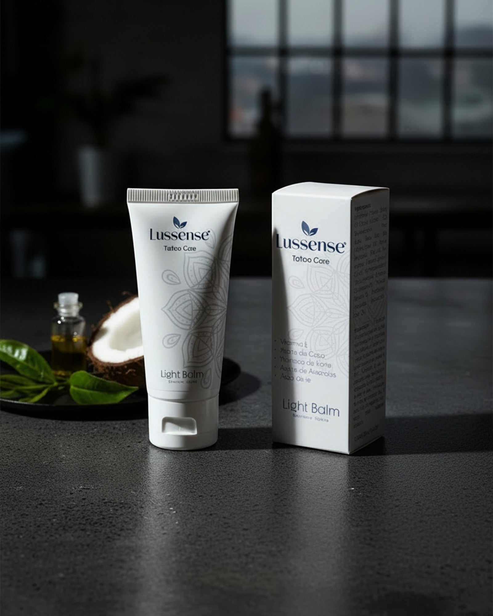 Lussense Light Balm tattoo care tube and box with coconut and green leaves. Natural tattoo balm for hydration and color enhancement.