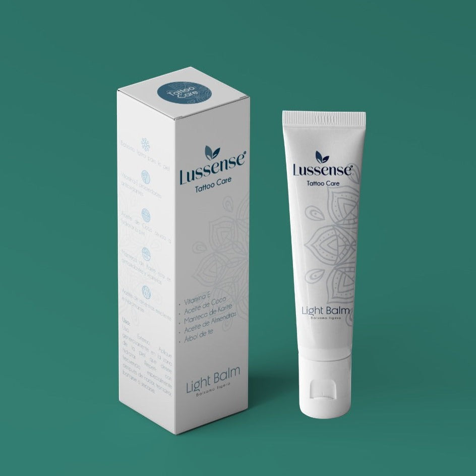 Lussense Tattoo Care light balm in a white tube with a mandala design. Packaging box also shown.