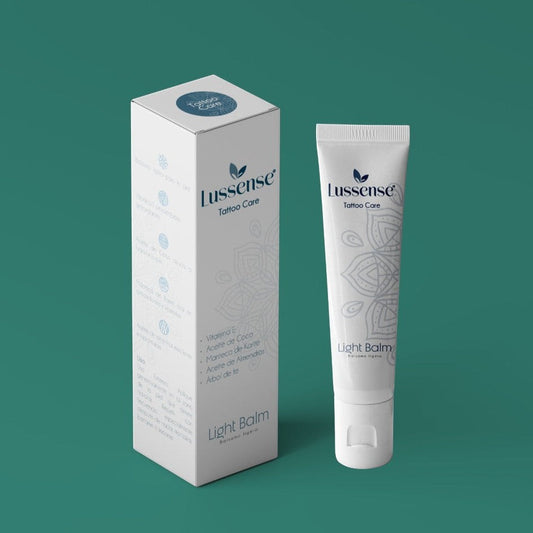 Lussense Tattoo Care light balm in a white tube with a mandala design. Packaging box also shown.